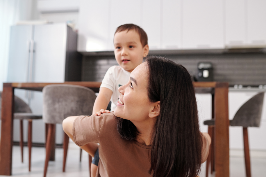 a woman holding a young boy on her back