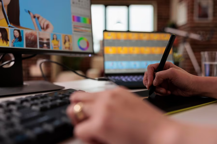 editor using a stylus on a graphic tablet with a monitor