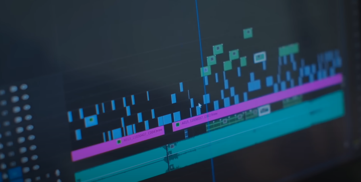 A monitor displaying Adobe Premiere Pro with an editing project in progress