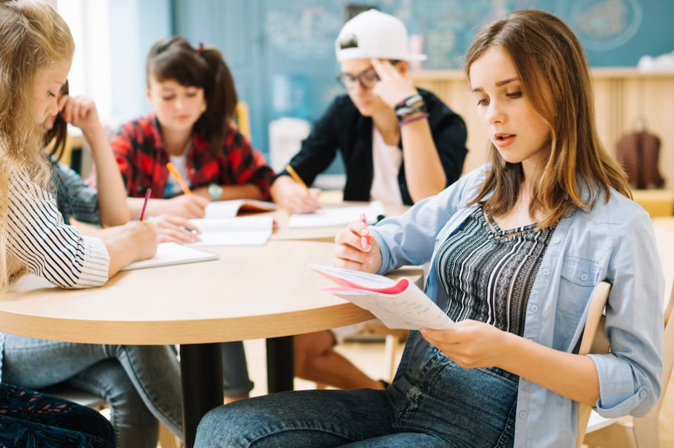 girl and her classmates write note in their books